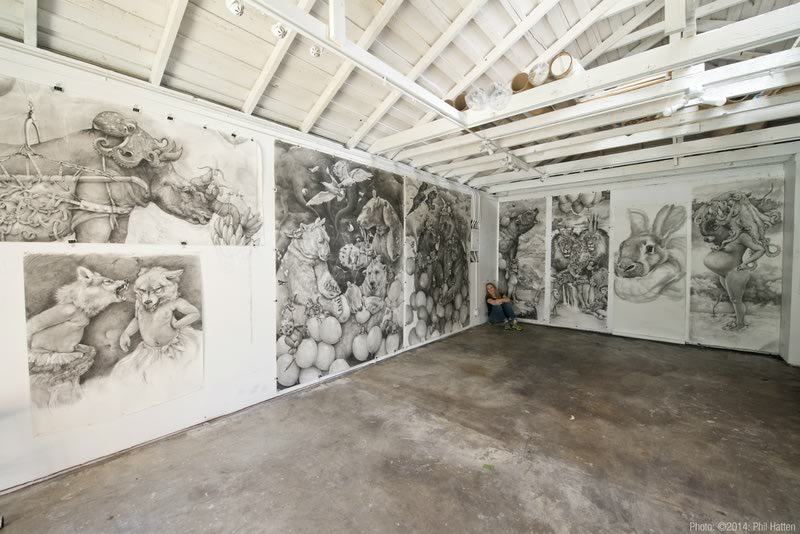 A gallery room with detailed pencil drawings covering the walls, from Adonna Khare's 'A Voice for the Wild'