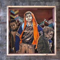 Mixed-media textile wall artwork depicting two figures in warm orange and blue tones