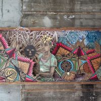 Elongated mixed-media wall artwork with colorful figures and geometric patterns