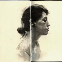 Sketchbook spread with two pencil portrait studies of a woman's face in profile