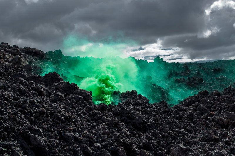 A dark rocky landscape at night with glowing green smoke, titled 'Silence/Shapes'