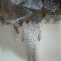 Ghostly photograph of a standing figure obscured by translucent fabric
