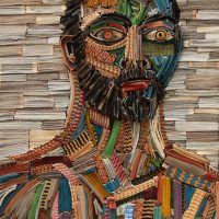 Mosaic-style collage portrait of a bearded man's face made of colorful strips
