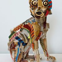 Mosaic-style sculpture of a dog made of colorful painted wood pieces