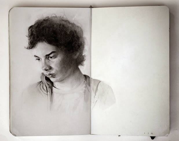 An open sketchbook showing a pencil portrait drawing of a woman with curly hair, drawings and sketches by Thomas Cian