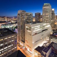 Night aerial photograph of an illuminated museum building in a city skyline