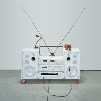 Sculptural boombox artwork with two antennas and red speaker cones