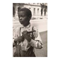 Sepia-toned vintage photograph of a boy wearing traditional clothing