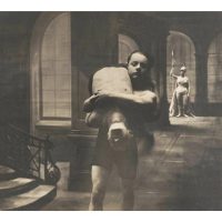Black-and-white photograph of two figures in period costume in a dim interior, one bowing