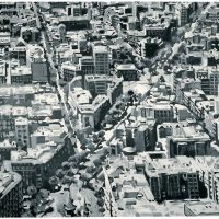 Aerial black-and-white photograph of a dense city street grid