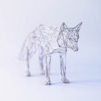 Wireframe sculpture of a wolf or dog in white wire mesh
