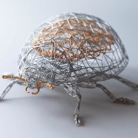 Wireframe sculpture of a beetle in white wire mesh